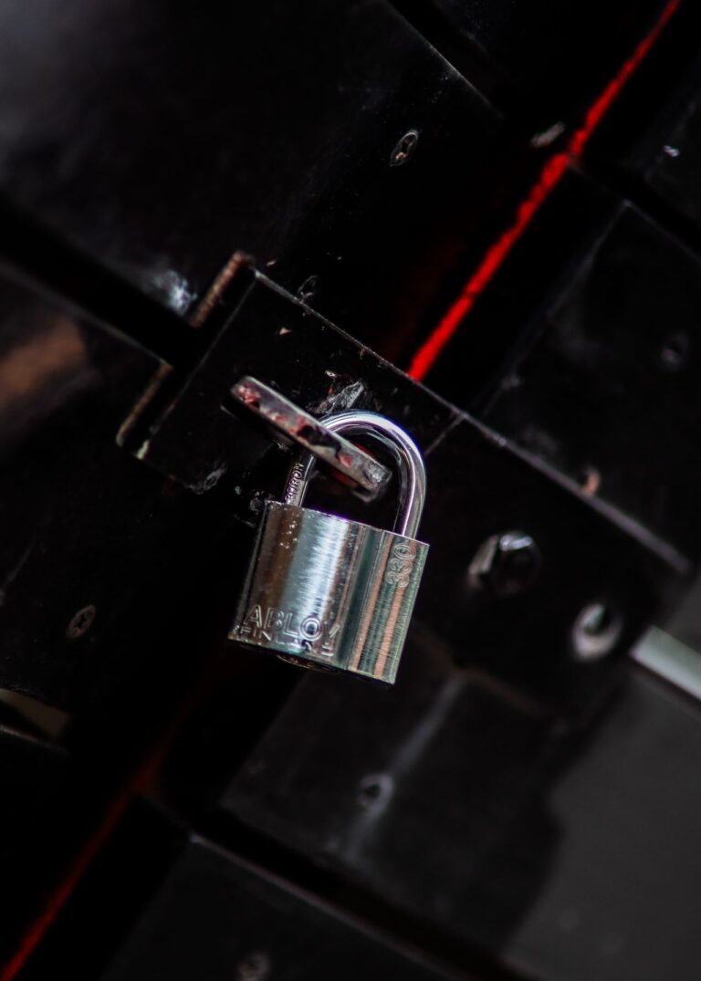 Metal padlock representing the decision between rekeying and replacing locks
