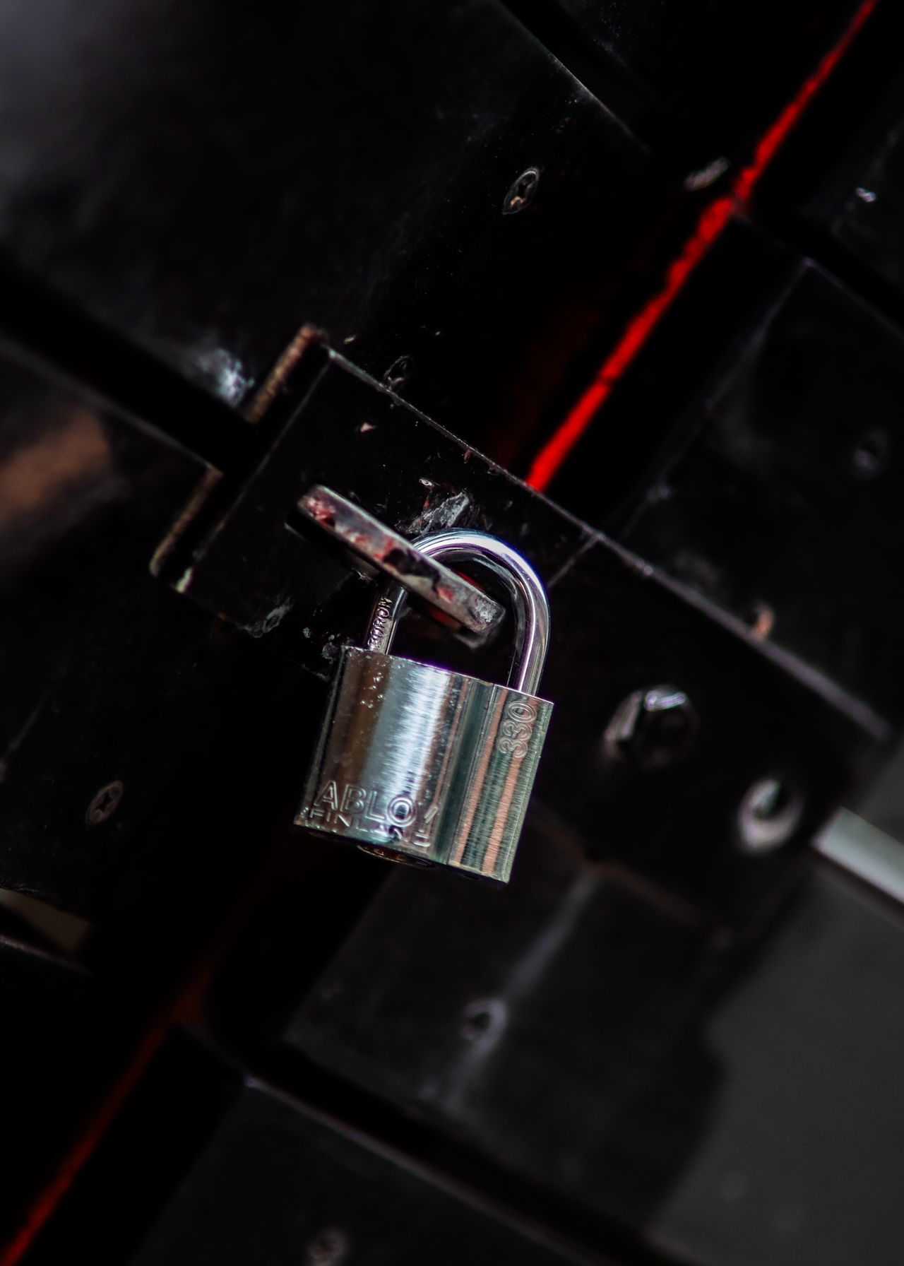 Metal padlock representing the decision between rekeying and replacing locks