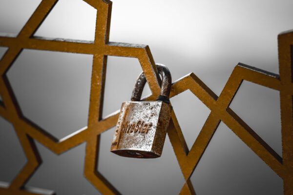 Padlock on a gate representing locksmith scam prevention in Houston TX
