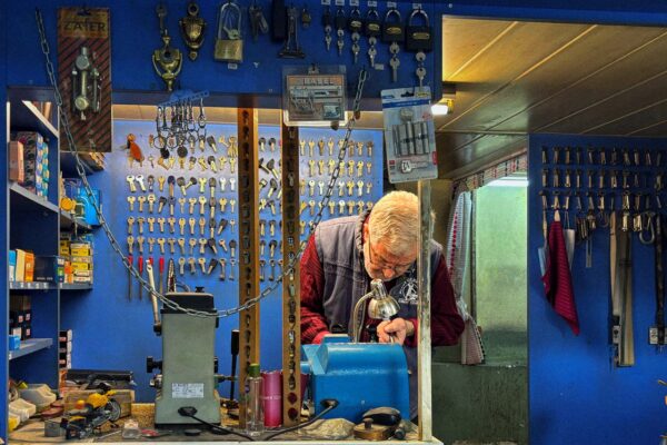 Locksmith preparing keys in a shop representing locksmith response times