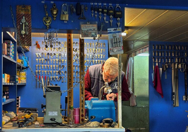 Locksmith preparing keys in a shop representing locksmith response times